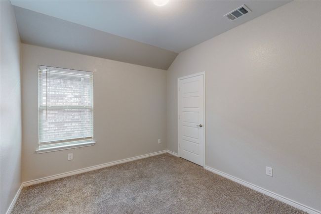 Unfurnished room with baseboards, visible vents, carpet, and vaulted ceiling | Image 30