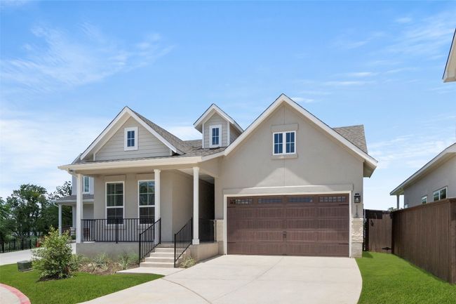 View of front of property featuring roof with shingles, concrete driveway, stucco siding, and covered porch | Image 6