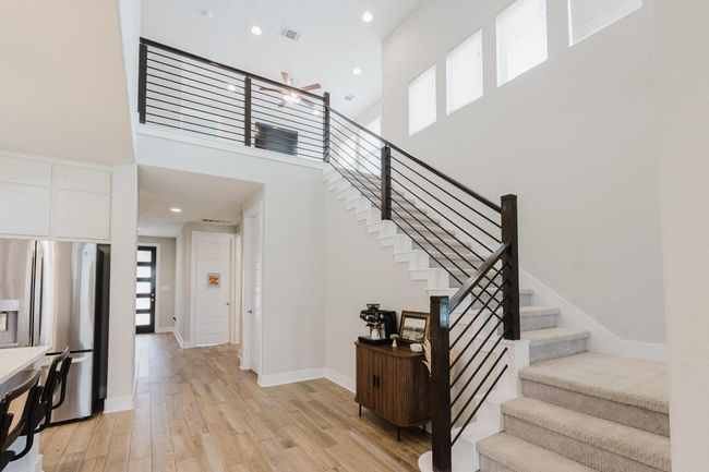 Stair to upstairs with black metal railing | Image 25