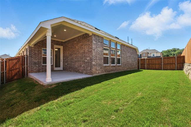 Rear view of house with a patio, brick siding, and a fenced backyard | Image 32