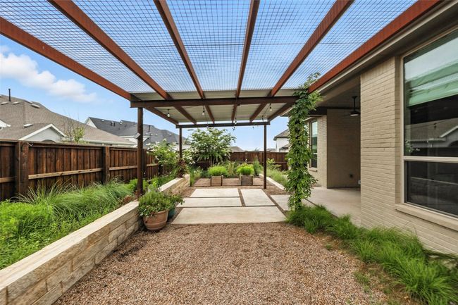 Fenced backyard with a pergola, a patio, and a garden | Image 34