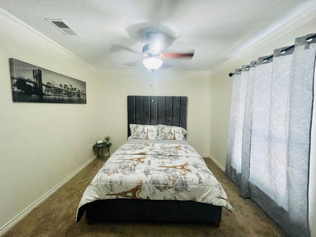 Bedroom featuring carpet floors, ornamental molding, baseboards, and ceiling fan | Image 12