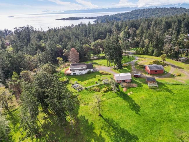 Aerial view of property and surrounding area with a forest and a nearby body of water | Image 48