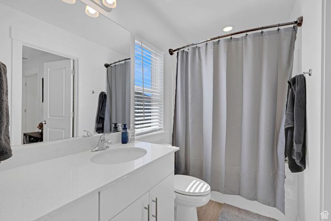 Full bathroom featuring vanity, toilet, and wood finished floors | Image 18