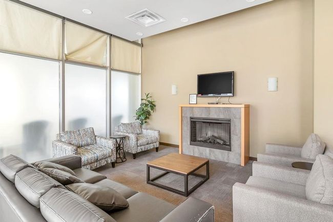 Living room with a premium fireplace and baseboards | Image 27