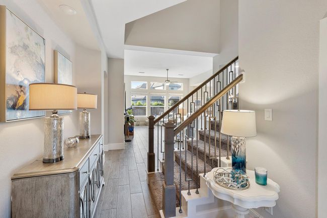 Welcome to this stunning open floor plan, where soaring ceilings and abundant natural light create a bright, airy, and perfectly balanced atmosphere. | Image 11