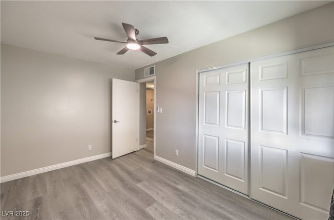 Unfurnished bedroom with ceiling fan, light wood-style flooring, visible vents, baseboards, and a closet | Image 25