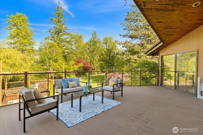 Spacious deck perfect for entertaining, unwinding, and taking in the peaceful natural surroundings. | Image 25