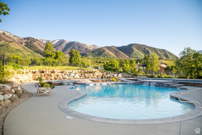 Community pool featuring a mountain view and a patio | Image 13