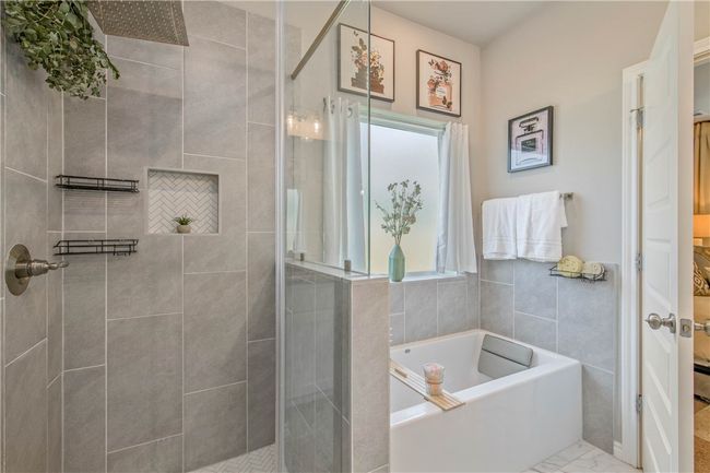 Bathroom featuring a garden tub and a stall shower | Image 25