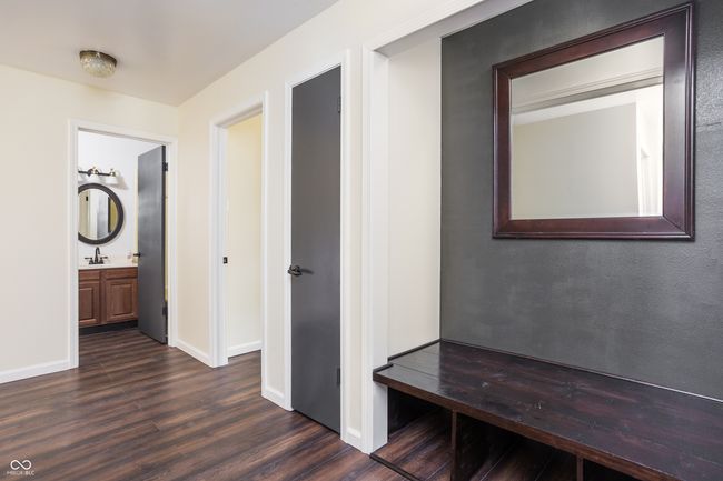 corridor featuring dark wood finished floors and baseboards | Image 19