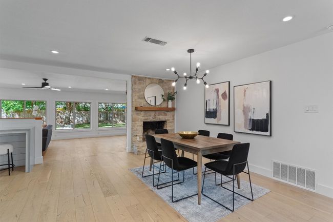 The living, dining, and kitchen flow effortlessly into a spacious family room | Image 8