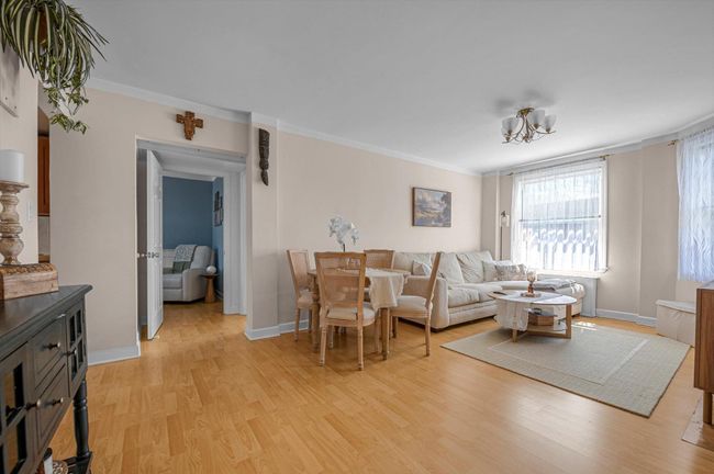 Living area featuring light wood-type flooring, baseboards, and crown molding | Image 4