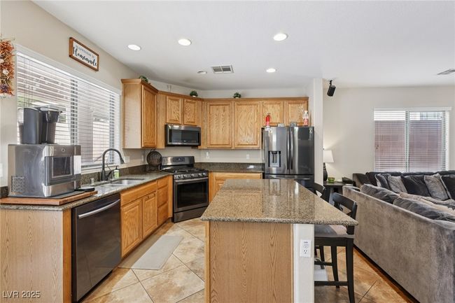 Kitchen featuring stainless steel appliances, a sink, light tile patterned floors, healthy amount of natural light, and recessed lighting | Image 29