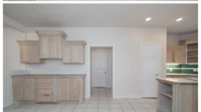 Kitchen with light brown cabinetry, recessed lighting, and light tile patterned floors | Image 10