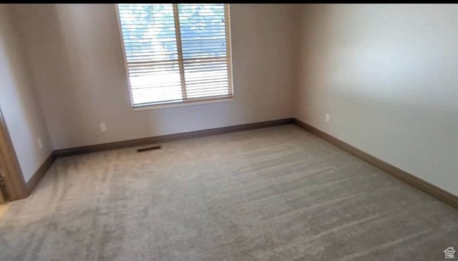 Unfurnished room with light carpet and baseboards | Image 69