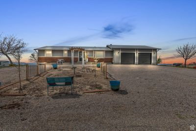 Single story home with a pergola and a garage | Image 1