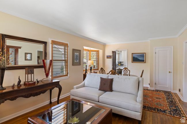 Living room with dark wood finished floors and crown molding | Image 9