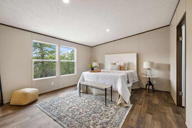 Bedroom featuring wood finished floors, a textured ceiling, recessed lighting, and crown molding | Image 22