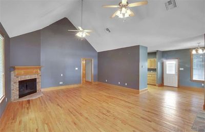 Living room with high ceilings & wood burning fireplace | Image 2