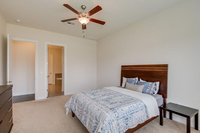 Bedroom featuring visible vents, baseboards, carpet floors, and ceiling fan | Image 16