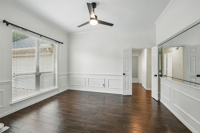 Spare room featuring ornamental molding, a ceiling fan, and wood finished floors | Image 7