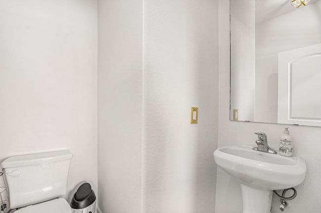 Half bathroom featuring toilet and a sink | Image 12