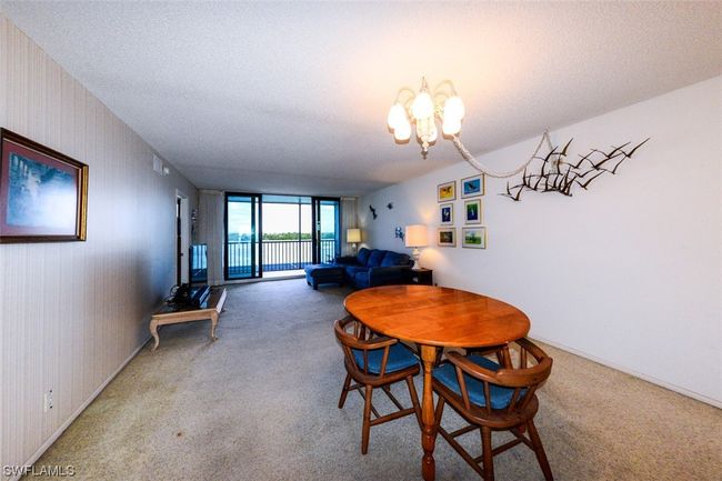 VIEW FROM DINING AREA TOWARD LIVING AREA AND LANAI. IMPACT RESISTANT LANAI DOORS. | Image 14
