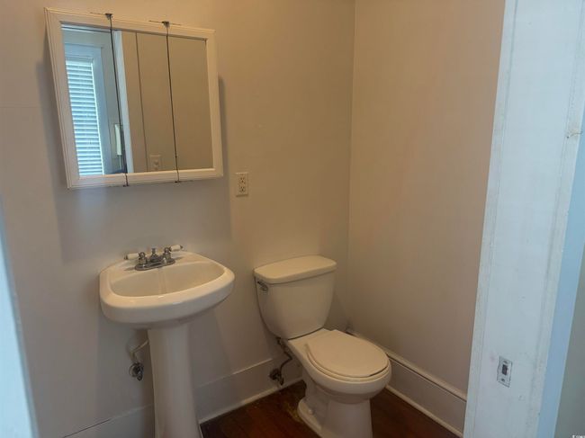 Half bathroom featuring toilet and a sink | Image 19