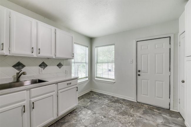 Kitchen featuring white cabinetry, tasteful backsplash, and light countertops | Image 12