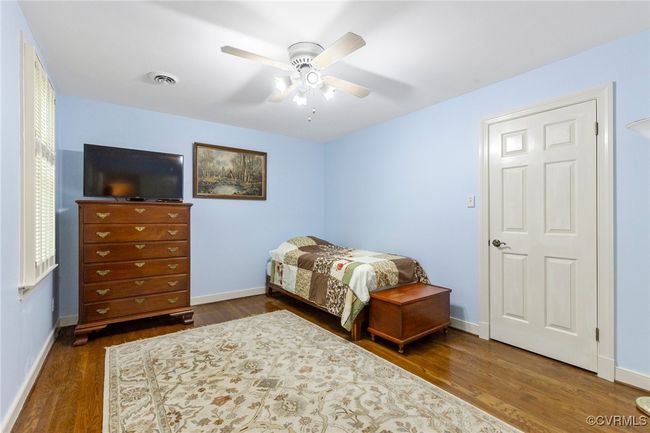 Bedroom featuring wood finished floors and a ceiling fan | Image 31