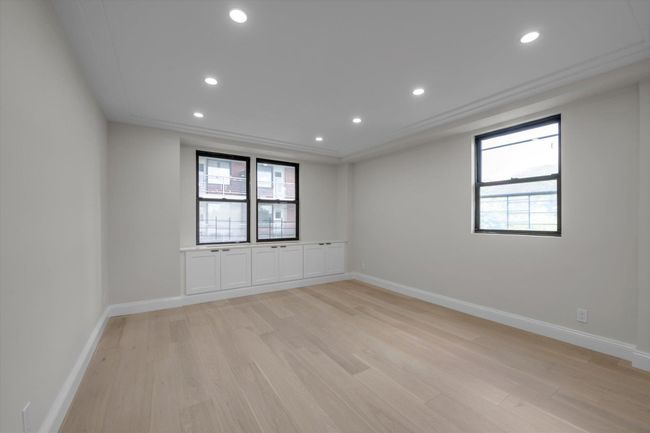 Empty room featuring light wood-style floors and recessed lighting | Image 8