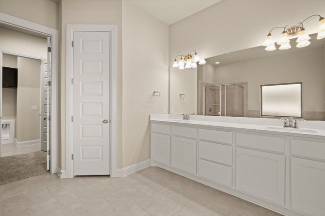 Full bathroom with a sink, a stall shower, double vanity, and a notable chandelier | Image 16