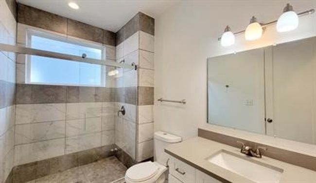 Full bathroom featuring a tile shower and vanity | Image 15