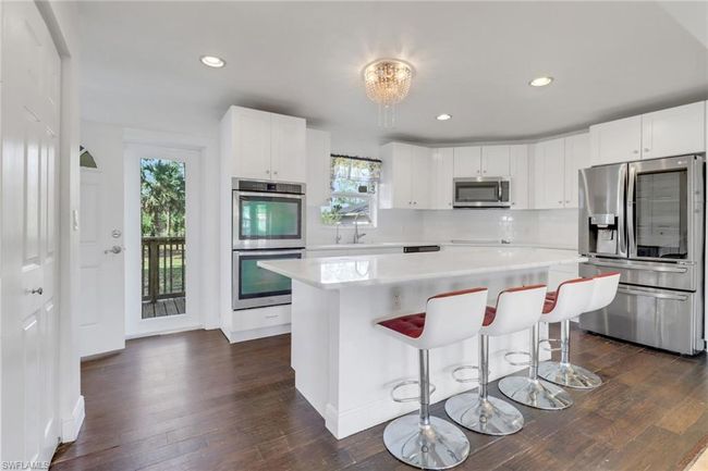 Another view of the kitchen. Tons of natural lighting. Large Pantry and Island - Great for entertaining! Ample Storage Space! | Image 7