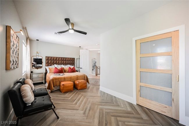Bedroom featuring baseboards, designer styled flooring and a ceiling fan | Image 50