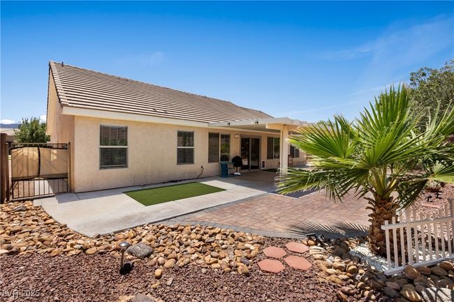 Back of house featuring stucco siding, a tile roof, a gate, and a patio | Image 36