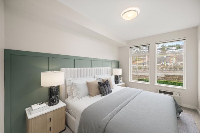 Bedroom with carpet floors, multiple windows, and a wall unit AC | Image 4