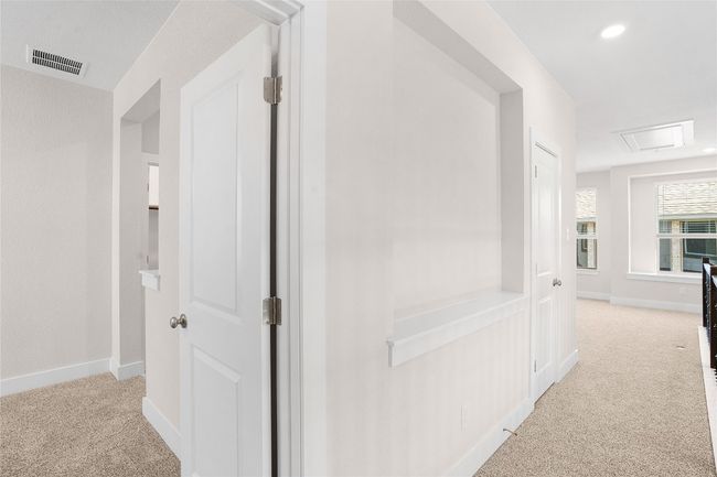 Hallway with carpet flooring, baseboards, and attic access | Image 23