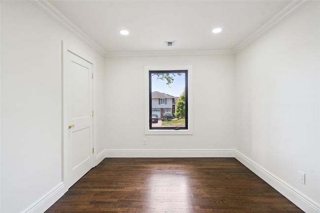 Spare room with dark wood-type flooring, crown molding, and recessed lighting | Image 26