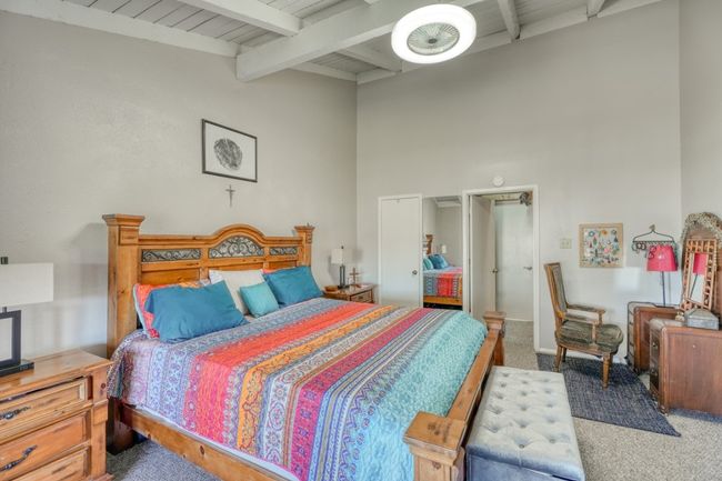 Carpeted bedroom featuring beam ceiling and closet upper unit | Image 23