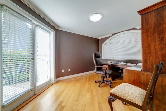 Office space with crown molding, light wood-style flooring, and baseboards | Image 9