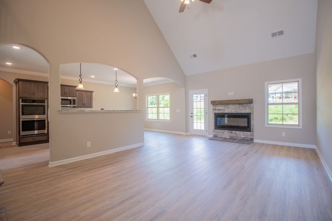 Spacious Living Room with a Stone Fireplace, Floating Wood Mantle, 2 Story Ceiling and Access to the Large Patio! | Image 5