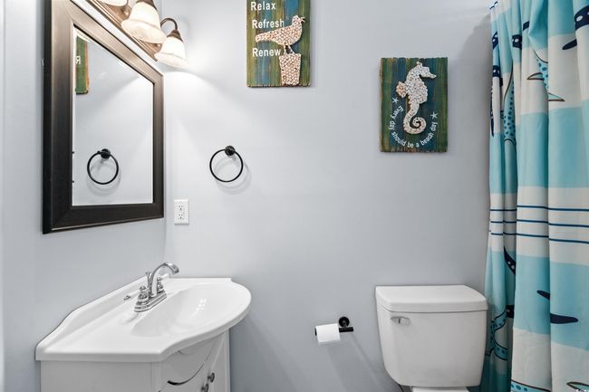 Bedroom with radiator heating unit, wood finished floors, and baseboards | Image 34