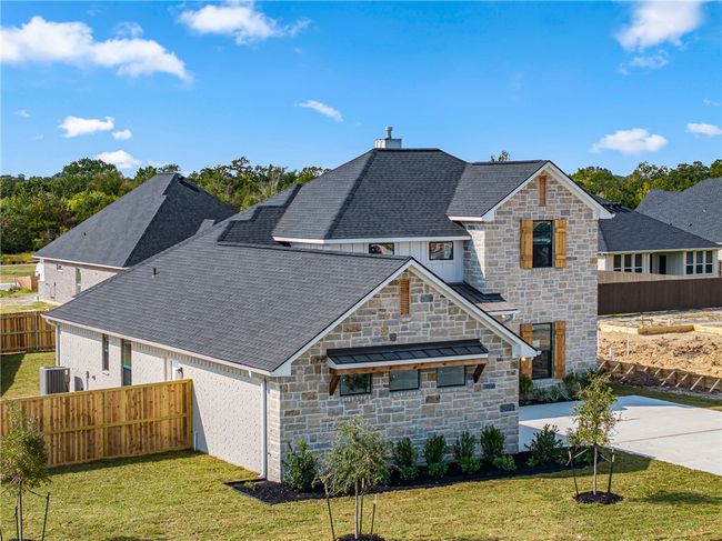 Back of property featuring a patio area, a lawn, and central AC unit | Image 48