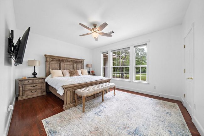 Bright bedroom with large windows and a serene view | Image 28