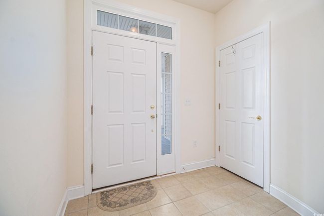 Foyer with light tile patterned floors and baseboards | Image 4