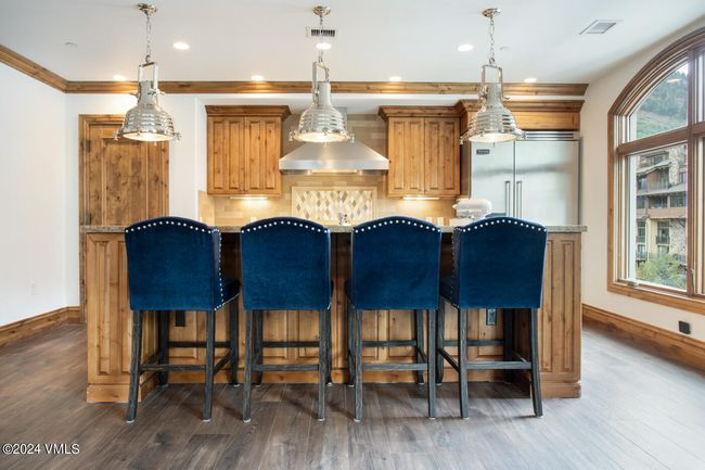 Classic meets contemporary in this chef-style kitchen featuring a Viking range, and Viking refrigeration, and island with bar seating—perfect for casual breakfasts or evening cocktails. | Image 5