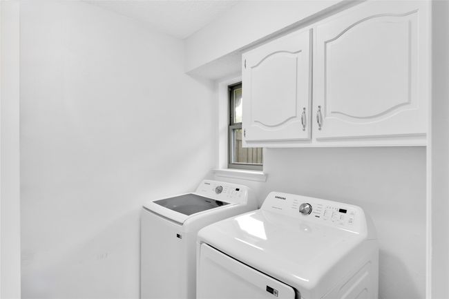 Washroom featuring cabinet space and washer and dryer | Image 27