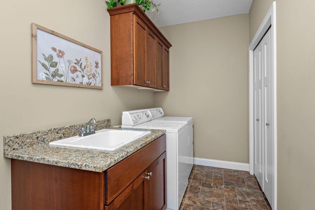 Nice Main Floor Laundry with utility sink and cabinets | Image 18